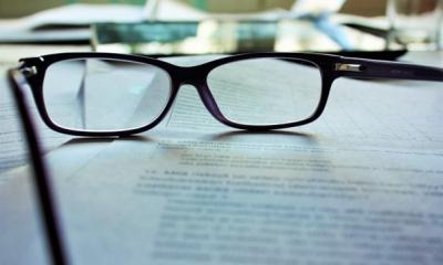 glasses resting on papers